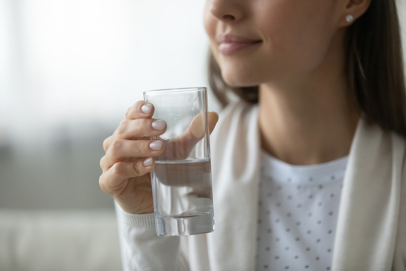 Smiling Woman Holding a Glass of Water