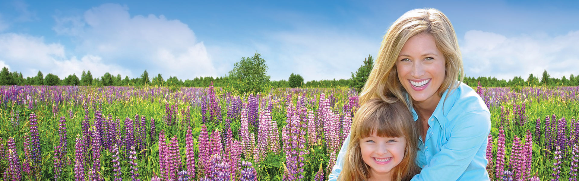 Mother and daughter in a field of flowers.
